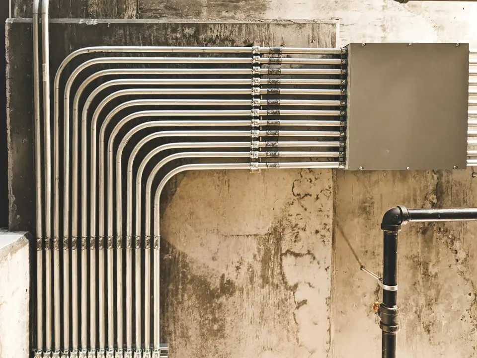 Metal water pipes along a building wall